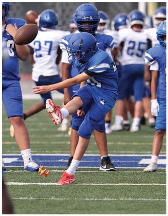A football player running on the field. Description generated by AI