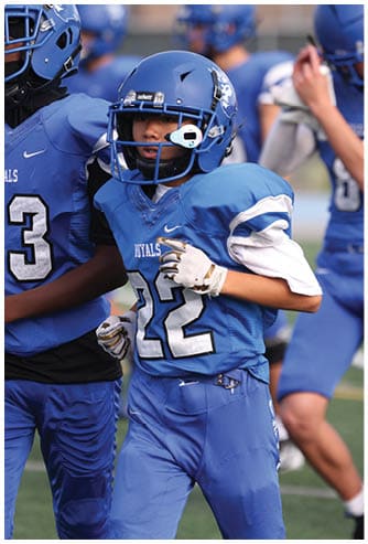 A football player running on the field. Description generated by AI
