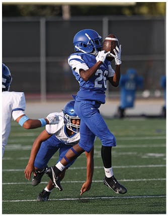 A football player running on the field. Description generated by AI
