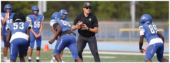 A football player is sliding on the ground. Description generated by AI
