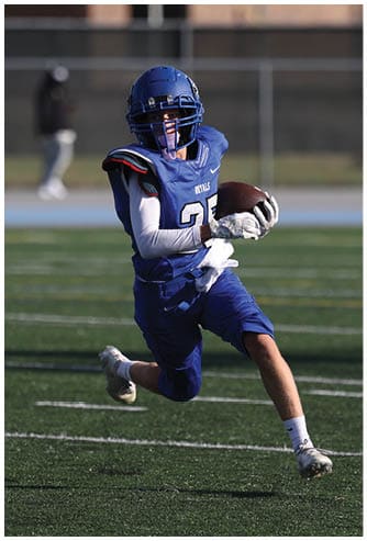 A football player running on the field. Description generated by AI