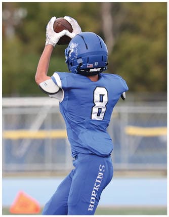 A football player running on the field. Description generated by AI