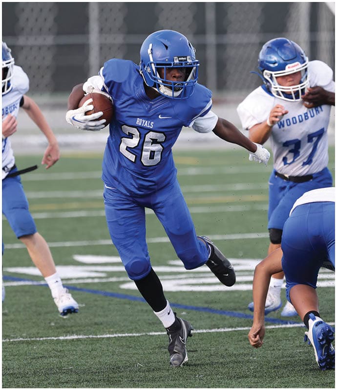 A group of football players wearing black and white uniforms. Description generated by AI