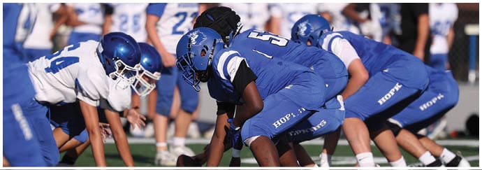 A group of football players on a field. Description generated by AI