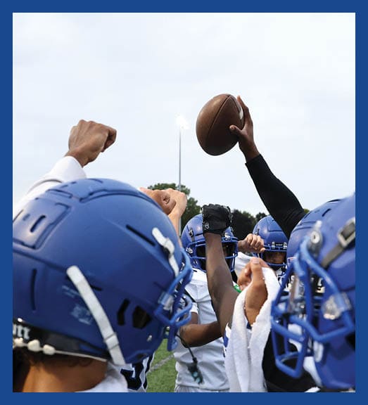 A football player in a white uniform is running with a football in his hand. AI generated content