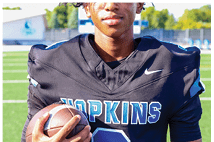 A young man wearing a white jersey with the number 10 on it. Description generated by AI