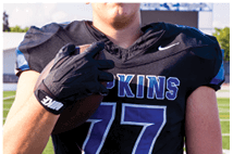 A young man wearing a white jersey with the number 10 on it. Description generated by AI