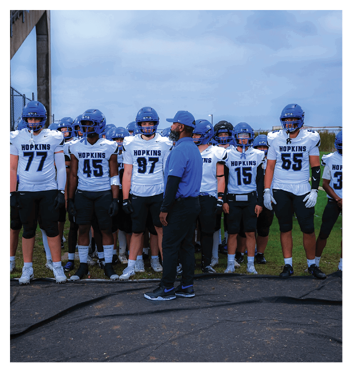 A group of football players walking on the field. AI generated content