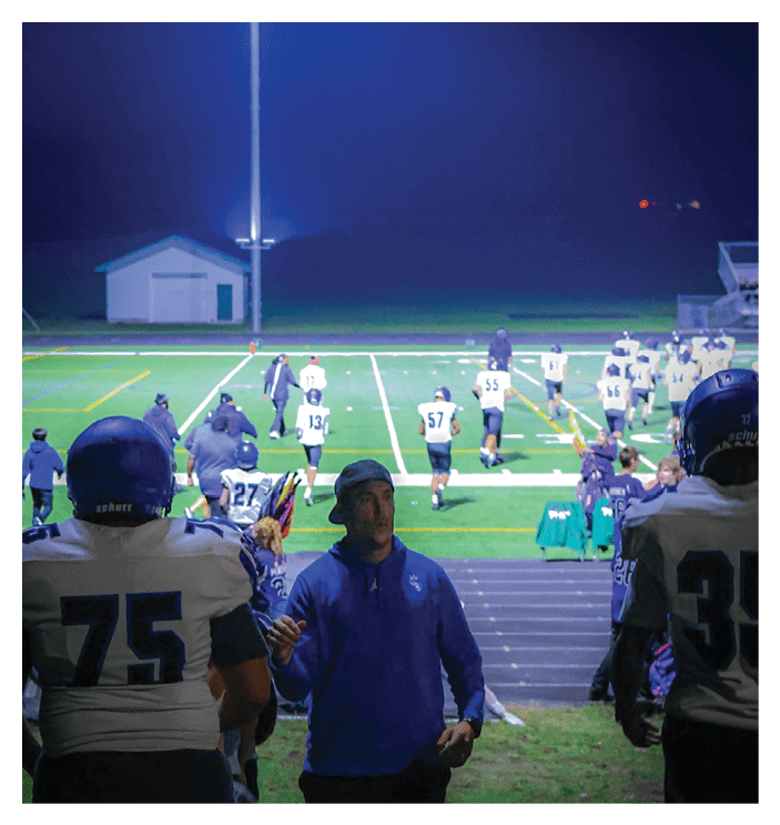 A group of football players walking on the field. AI generated content