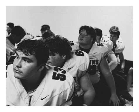 A group of young men wearing black jerseys with the word “Vista" on the front are celebrating a victory. AI generated content