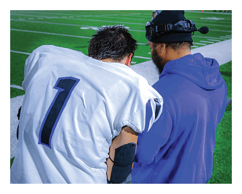 Two football players celebrating a touchdown with one player jumping in the air. AI generated content