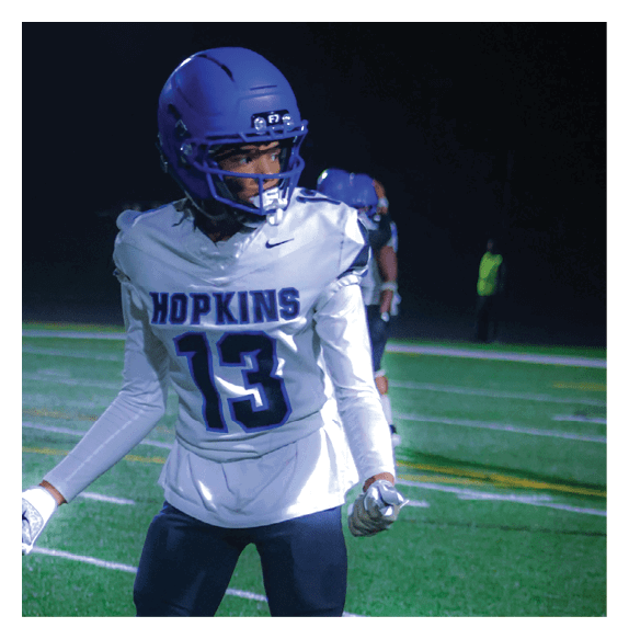 Two football players wearing Vista jerseys and holding hands. AI generated content