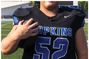 A young man wearing a white jersey with the number 10 on it. Description generated by AI