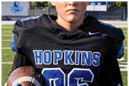 A young man wearing a white jersey with the number 10 on it. Description generated by AI