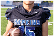 A young man wearing a white jersey with the number 10 on it. Description generated by AI