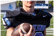 A young man wearing a white jersey with the number 10 on it. Description generated by AI