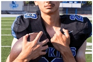 A young man wearing a white jersey with the number 10 on it. Description generated by AI