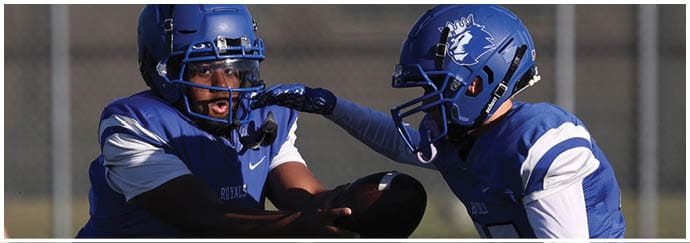A group of football players on a field. Description generated by AI