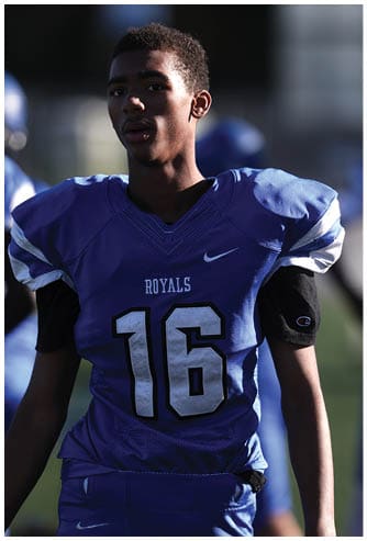 A football player running on the field. Description generated by AI