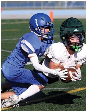 A football player running on the field. Description generated by AI