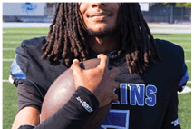 A young man wearing a white jersey with the number 10 on it. Description generated by AI