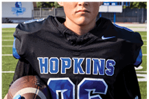 A young man wearing a white jersey with the number 10 on it. Description generated by AI
