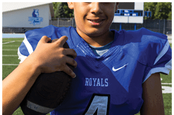 A young man wearing a white jersey with the number 10 on it. Description generated by AI