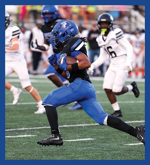 A football player in a white uniform is running with a football in his hand. AI generated content