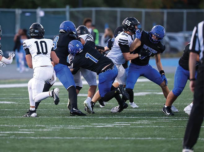 A group of football players in black and white uniforms are on the field. AI generated content