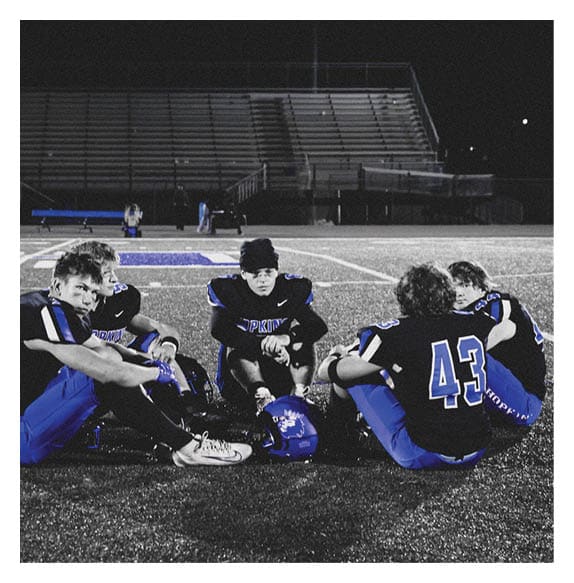 Two football players wearing Vista jerseys and holding hands. AI generated content