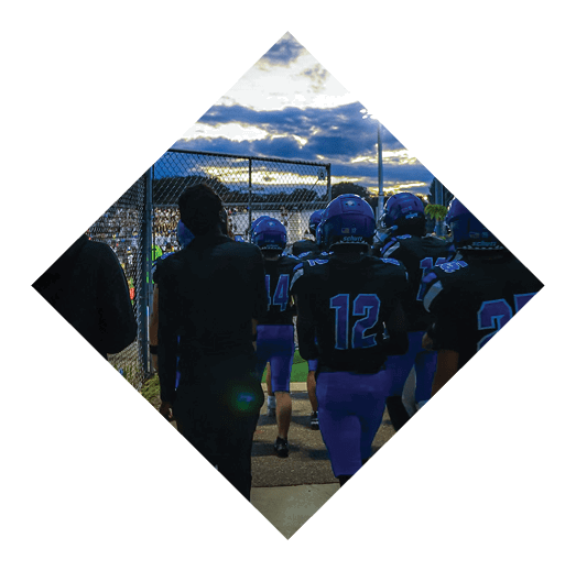 A football player wearing a black jersey with the number 16 on it is holding a football. AI generated content