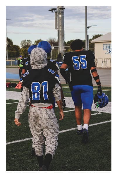 A football player wearing a black and white uniform with the number 10 on the back. AI generated content