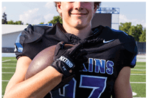 A young man wearing a white jersey with the number 10 on it. Description generated by AI
