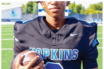 A young man wearing a white jersey with the number 10 on it. Description generated by AI
