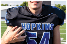 A young man wearing a white jersey with the number 10 on it. Description generated by AI