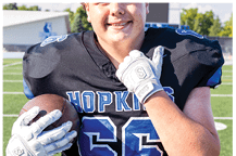 A young man wearing a white jersey with the number 10 on it. Description generated by AI