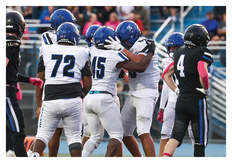 A group of football players on a field, one of them is running with a football. AI generated content