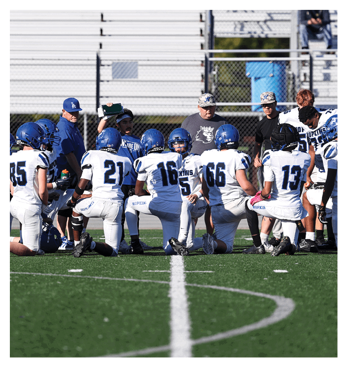 A group of football players walking on the field. AI generated content