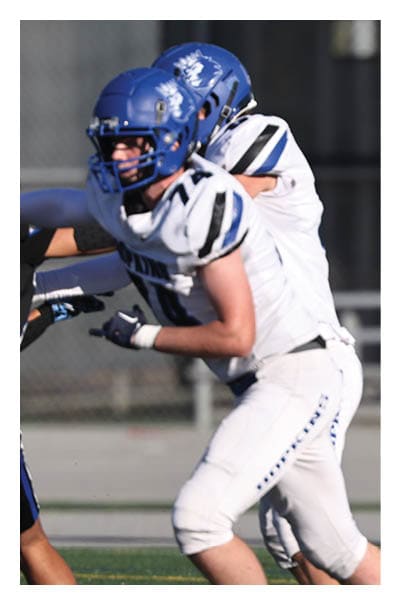 A football player wearing a black and white uniform with the number 10 on the back. AI generated content