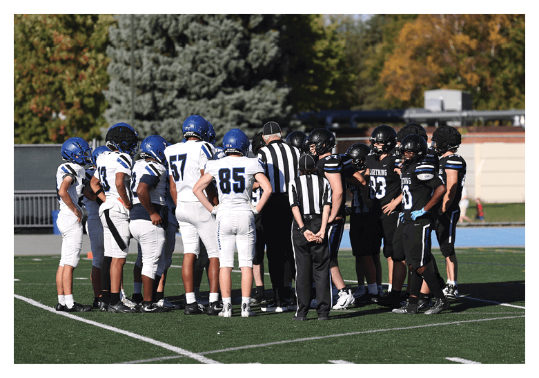 A group of football players on a field, one of them is running with a football. AI generated content