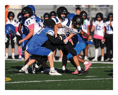 A man wearing a football uniform is jumping to catch a football. AI generated content