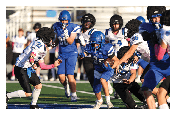 A group of football players wearing headphones and smiling. AI generated content