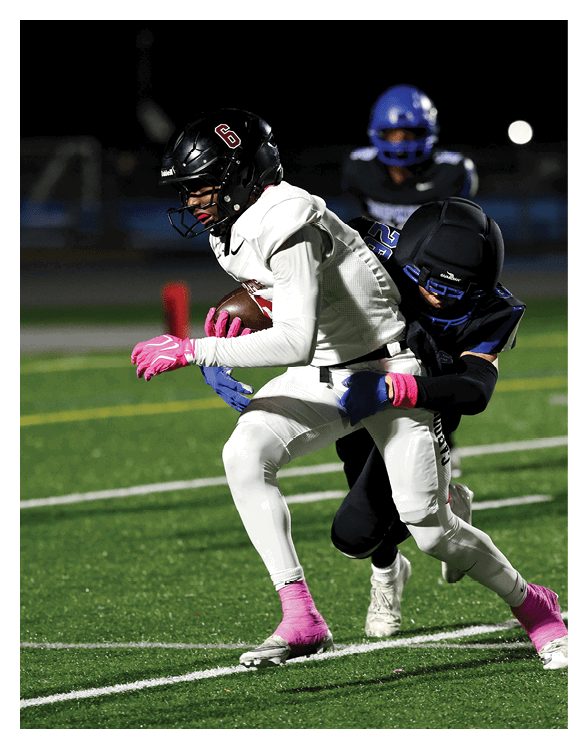 A football player wearing a helmet and white uniform is holding his helmet above his head. AI generated content