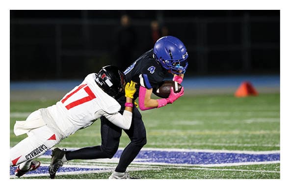 A group of people are kneeling on a field, possibly in a football game. AI generated content