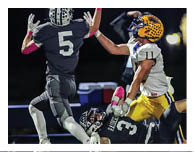 Two football players wearing black jerseys and holding hands. Description generated by AI
