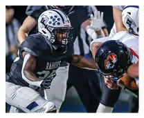 Two football players wearing black jerseys and holding hands. Description generated by AI