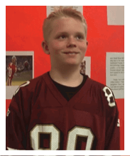 Two football players wearing black jerseys and holding hands. Description generated by AI
