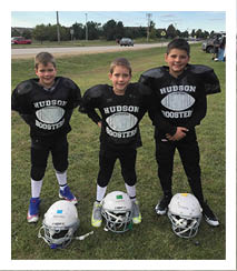 Two football players wearing black jerseys and holding hands. Description generated by AI