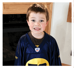 Two football players wearing black jerseys and holding hands. Description generated by AI