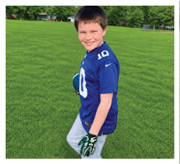 Two football players wearing black jerseys and holding hands. Description generated by AI